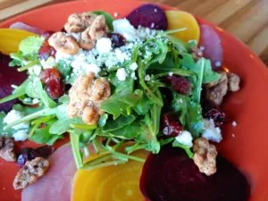 Beet salad on a plate with garnishes