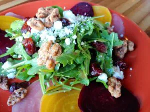 Beet salad on a plate with garnishes