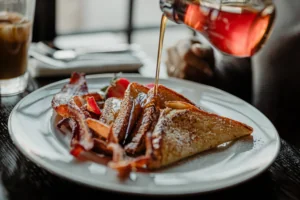 French toast with maple syrup being poured