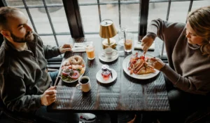 People eating breakfast food on plates