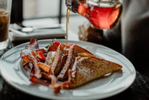 French toast with maple syrup being poured