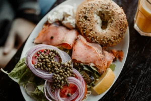 Bagel with Salmon on plate with garnishes