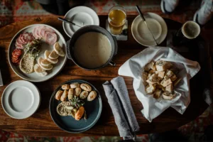 Charcuterie food on plates with dipping sauce