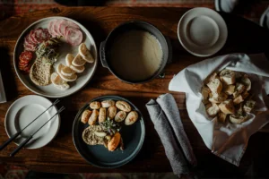 Charcuterie food on plates with dipping sauce