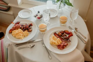 Breakfast food on plates with orange juice