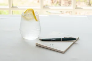Wentworth Notepad and pen with a drink