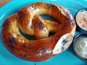 Pretzel with dipping sauce on plate