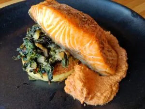 Salmon on a plate with garnishes
