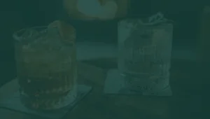green tinted photo of cocktail drinks on table